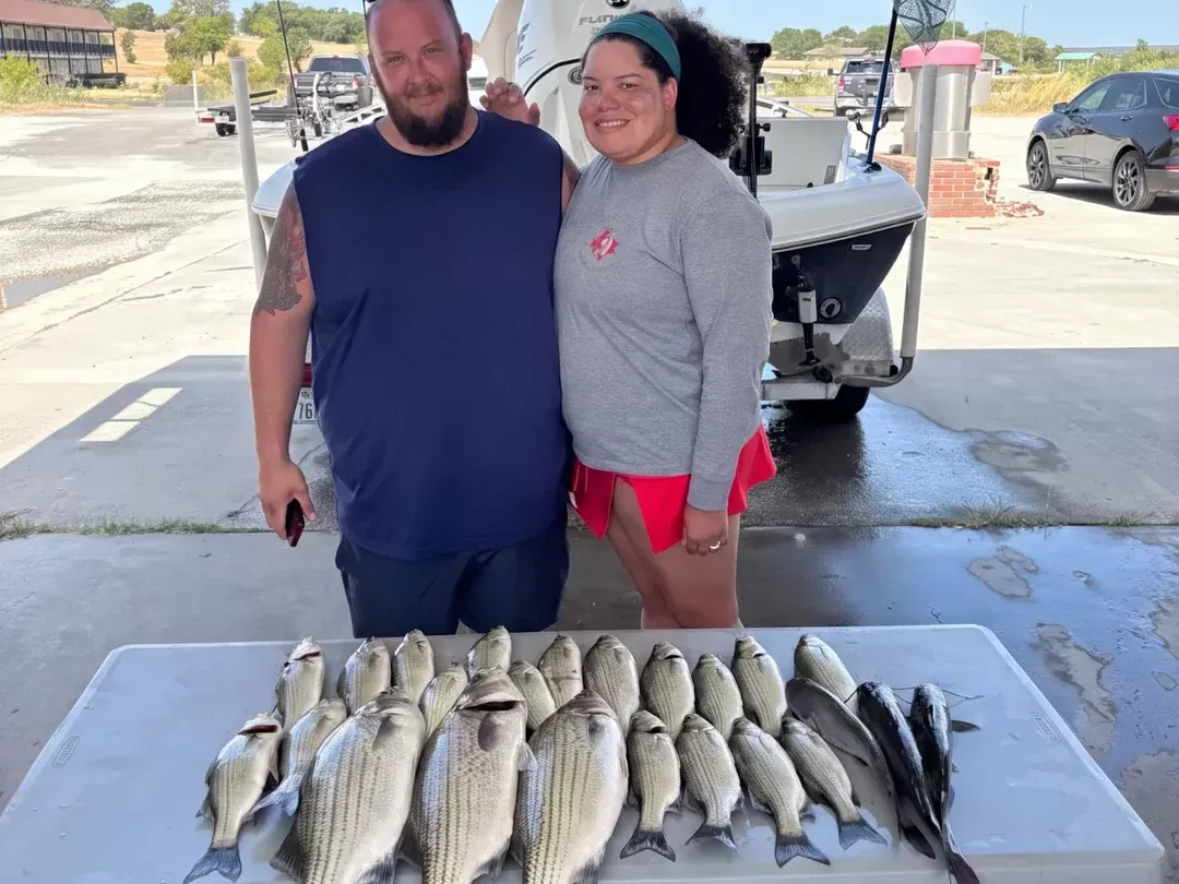 Two anglers with their catch on the cleaning table at Lake Bridgeport